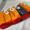 Four Gear Perspective Micro bags, three orange and one black and white